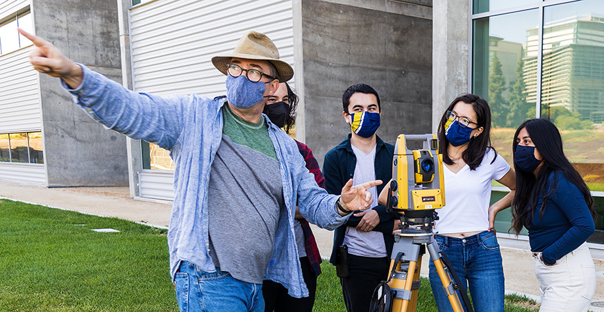 Professor Thomas Harmon shows students how to use Topcon Positioning Systems equipment on campus.