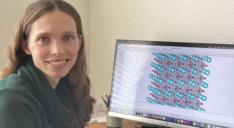 Professor Elizabeth Nowadnick with a computer visualization of a ferroelectric crystal structure.