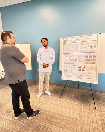 grad student presents poster