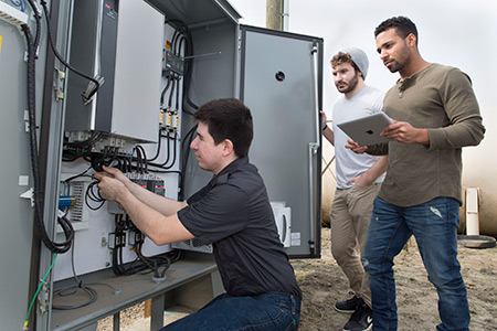 Agustin Roldan, front, Tamba Baldé, center, and Matt Fostiropuls are three of the four members of Sweep Energy,  startup that is working to help area farms monitor their energy use.