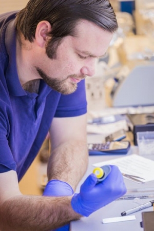 Student John Wilson using pipet