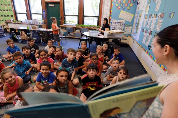 Teacher reading to a class of young students
