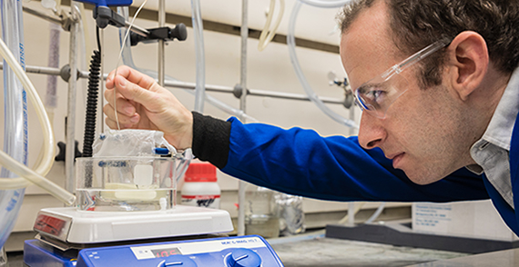 Postdoctoral researcher Rob Jordan works with 3D printer material